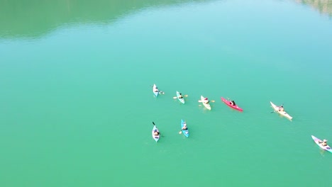 fun moment young and adult people paddling kayak in the lake of the barcelona mountains