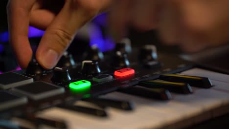 Music-producer-adjusts-knobs-for-effects-and-volume