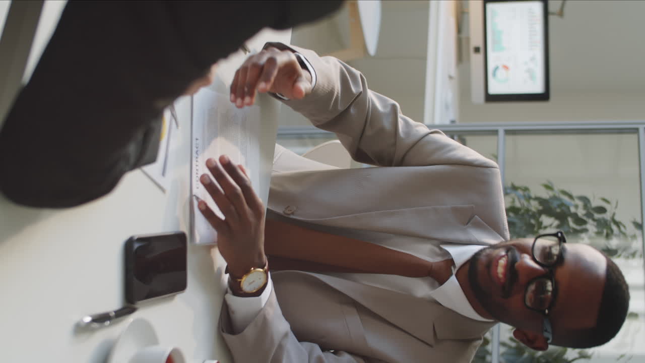 African American Businessman Giving Handshake to Partner at Office Meeting