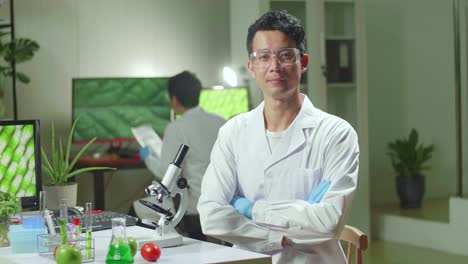 portrait of biologist man analyzing genetically modified organism for microbiology experiment. chemist scientific analyzing organic plants working in microbiology agriculture laboratory