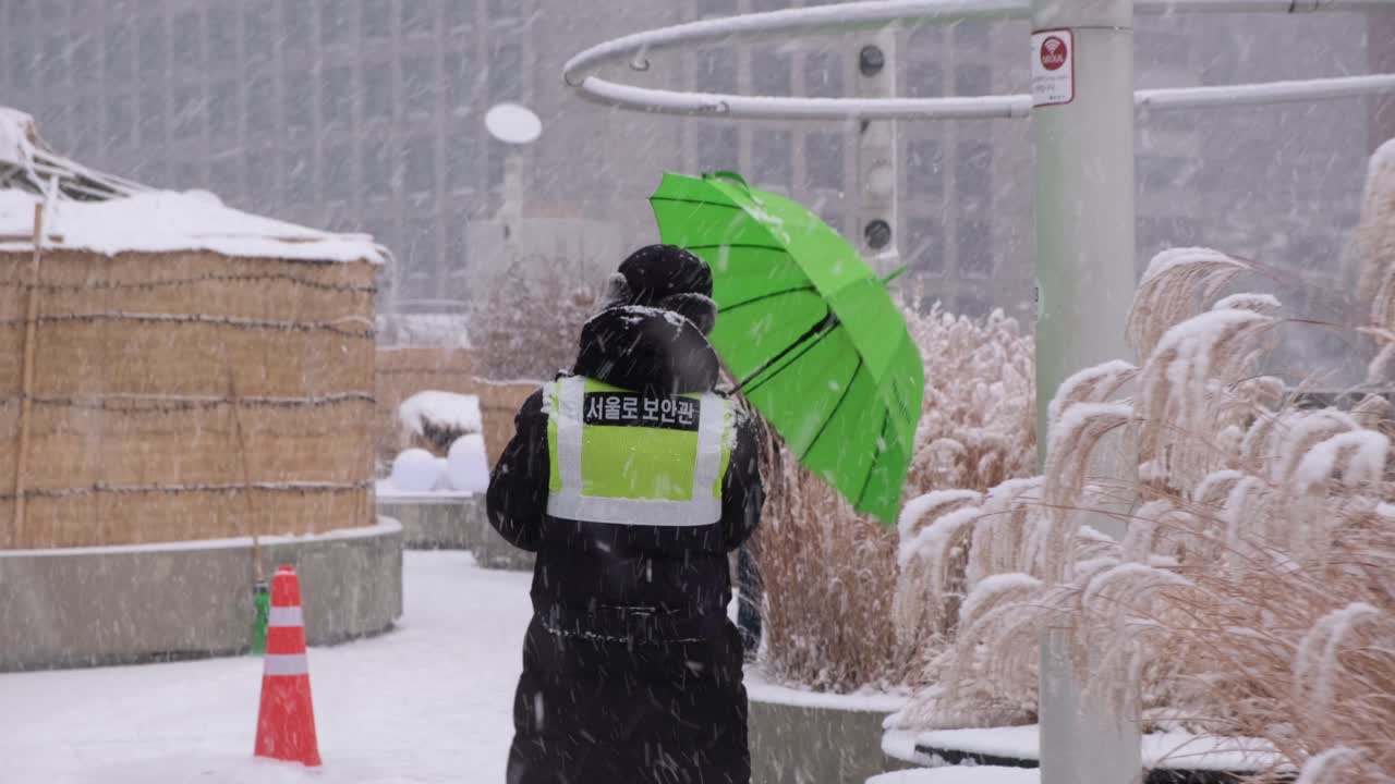 Unidentifiable faceless person walking in heavy snow storm, Seoul South Korea