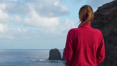 tourist enjoying panoramic view of roque partido in gran canaria island. canary islands. spain