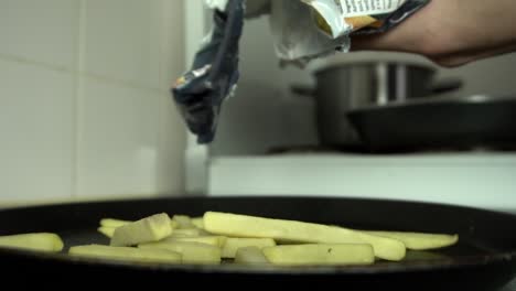 preparing oven fries to be baked in the oven ready to be served for dinner, slow motion shot