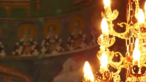 church fresco interior with a candlelight in the foreground