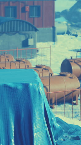 covered tanks in an industrial area in the winter