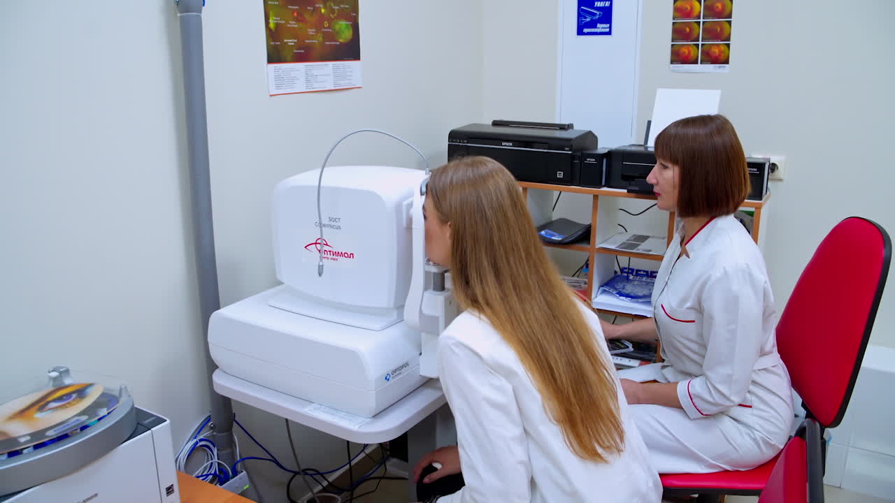 Optometrist working with patient. Ophthalmologist checks the vision of young patient