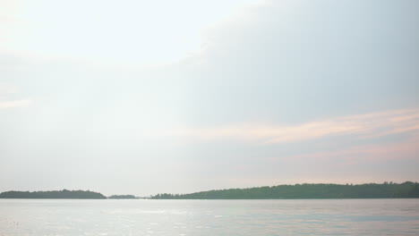 handheld shot of the st. lawrence river from wellesley island state park, fineview, ny. soft sky tones meet shimmering waters for a tranquil view.