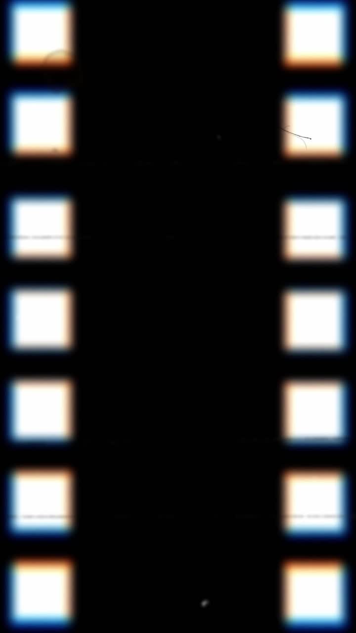 Vertical seamless loop of a vintage film strip with sprocket holes, dust and scratches running on a black background Perfect for retro-style social media stories and reels