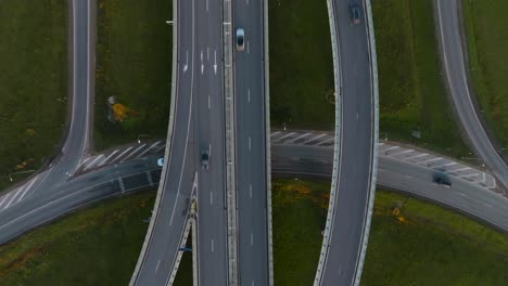 An-aerial-view-a-country-highway-with-a-bridge-and-overpasses-on-which-cars-and-trucks-travel