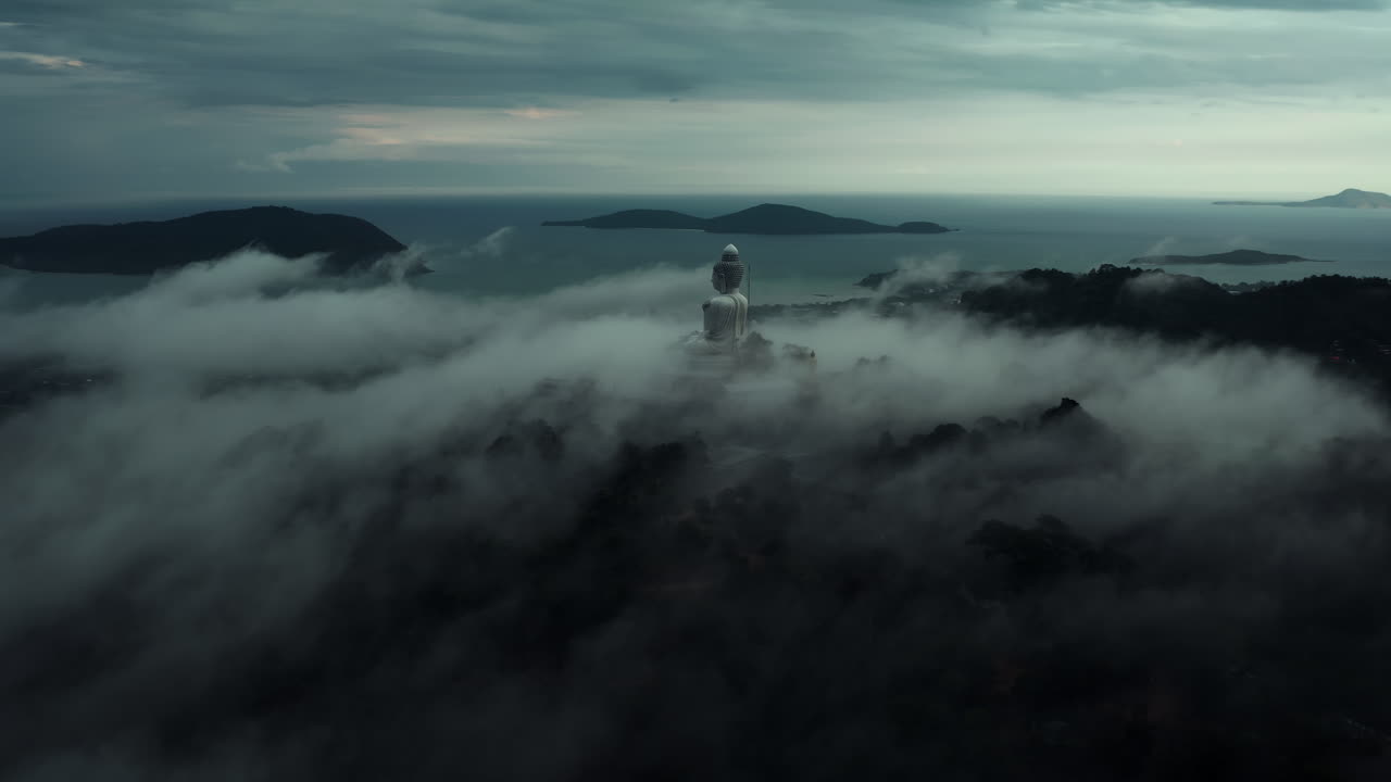 Misty Sunrise View of a Giant Buddha Statue in Thailand