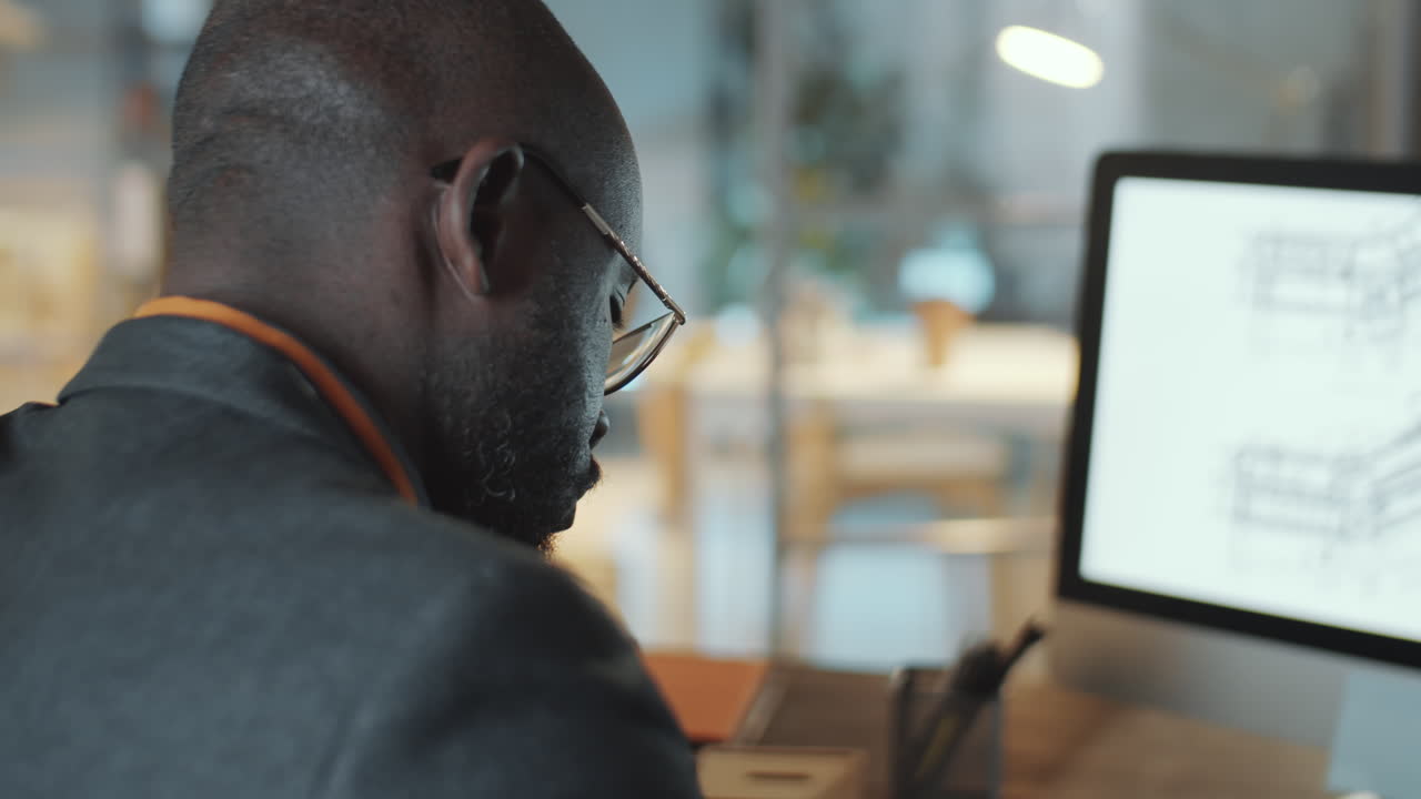 African American Architect Working in Office during Night