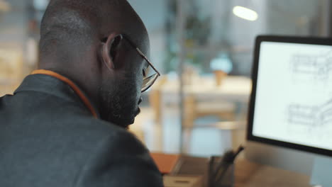 african american architect working in office during night