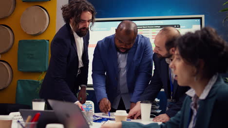 business associates reviewing latest financial plans on documents