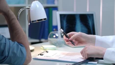 Doctor-hand-measuring-pulse-at-medical-workplace.-Woman-check-heart-rate