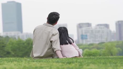 happy family in the outdoor outing having a picnic in the park, concept of destination, family travel and summer vacation or holidays