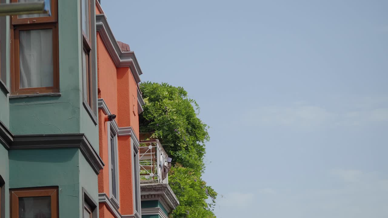 Exterior view of a building with greenery and a balcony