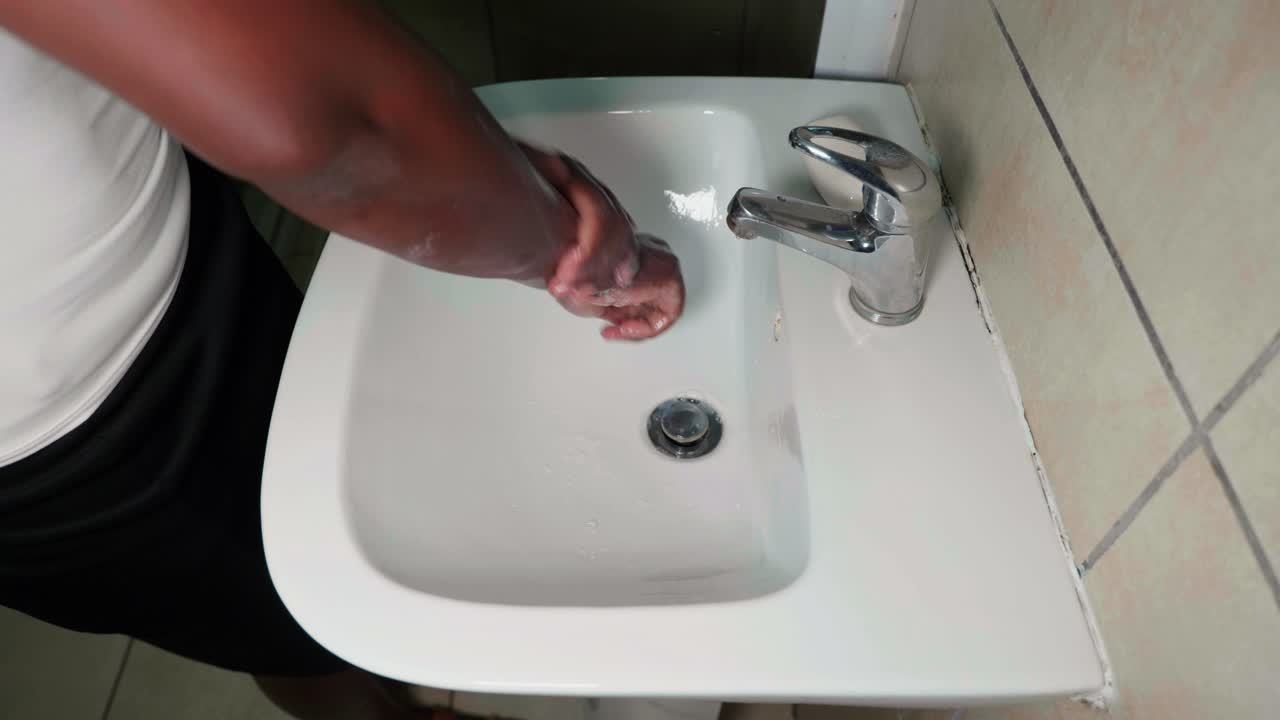 African lady washing hands with soap for covid-19