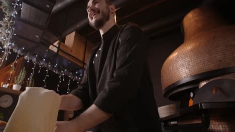 chef preparing pizza in restaurant