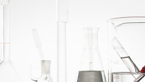 video of glass laboratory test tubes and dishes with copy space on white background