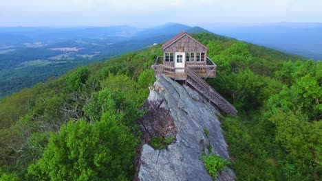 Rise-up-aerial-parallax-shot-of-fire-watch-tower-and-landscape