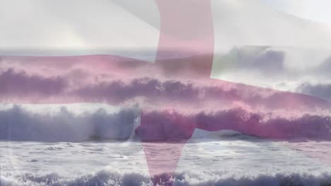 digital composition of england flag waving against waves in the sea