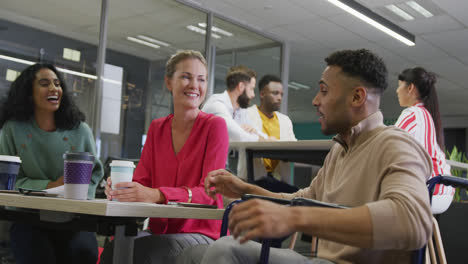 Happy-diverse-male-and-female-business-colleagues-working-in-office