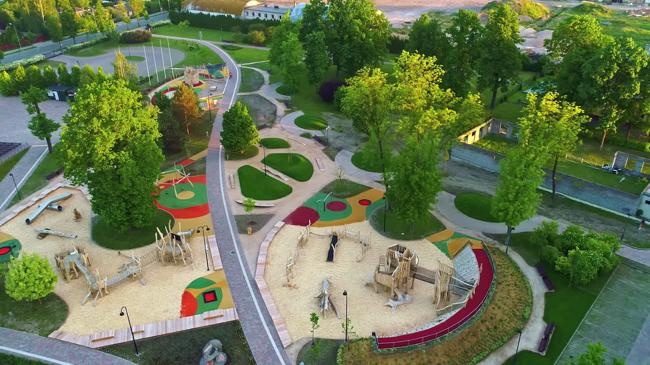 Newly landscaped public park, playground, and urban green space - aerial parallax