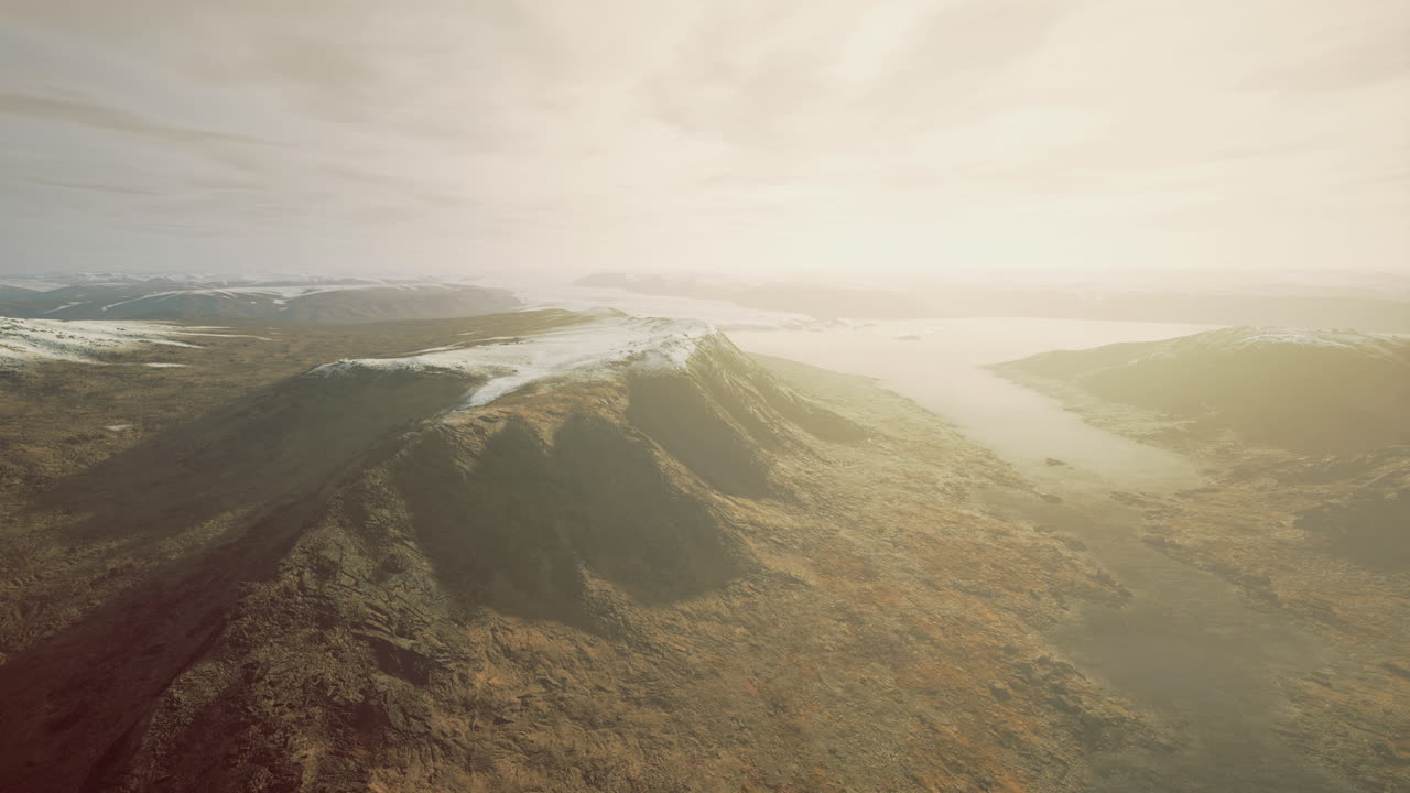 Sky view over rugged mountains and winding river in early morning light