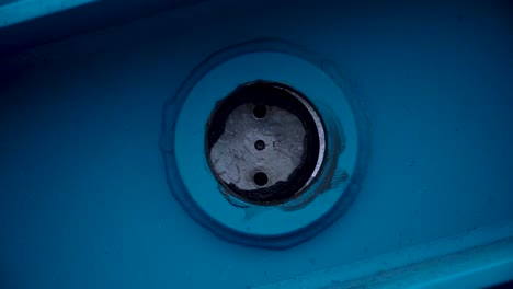 close-up of a blue metal part with a circular repair