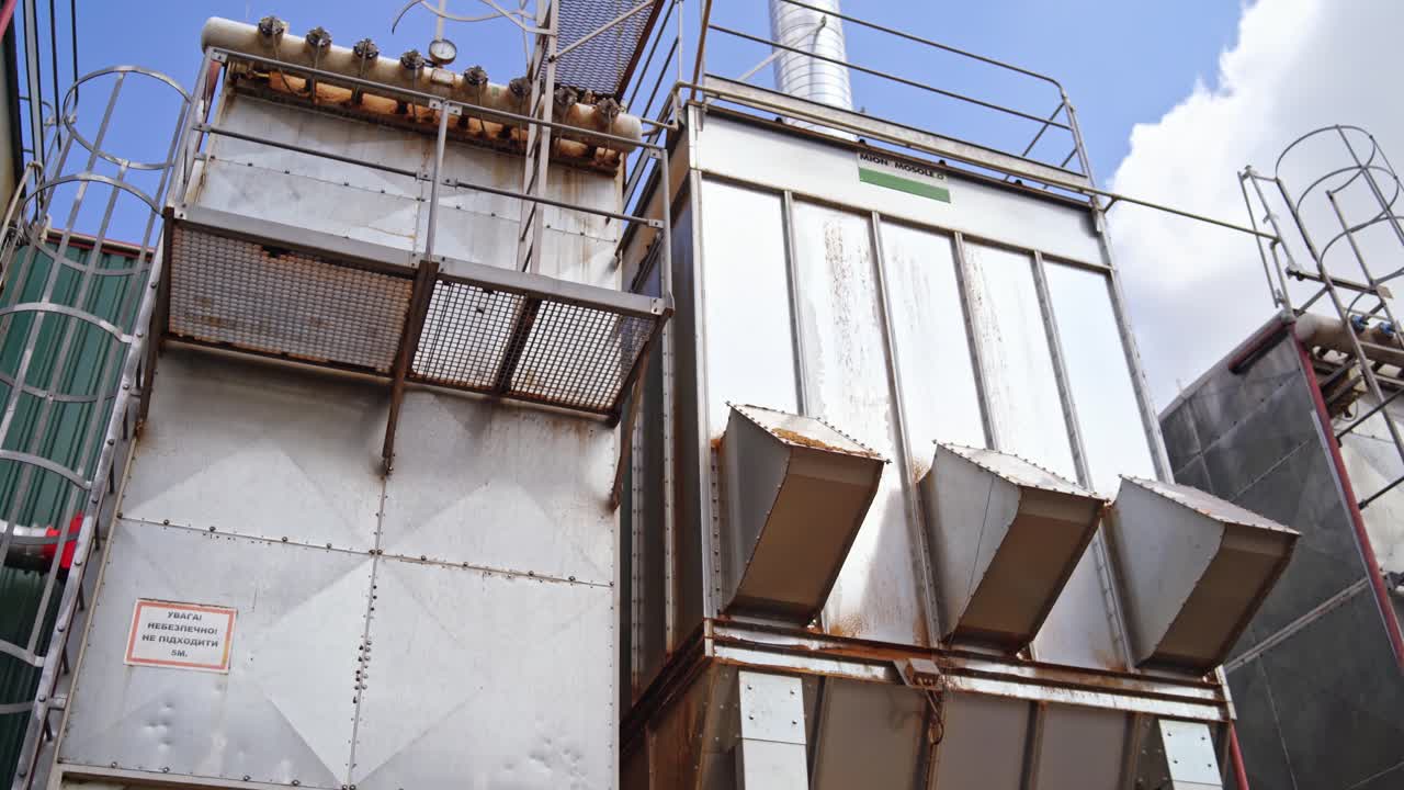 Modern factory outdoors. Huge industrial background of a new plant under blue sky. Exterior of sawmill manufacturing.
