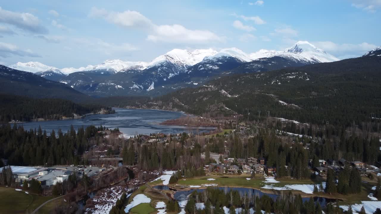 Incredible drone shot of Canadian nature. Snowy mountains and lakes with conifer forest