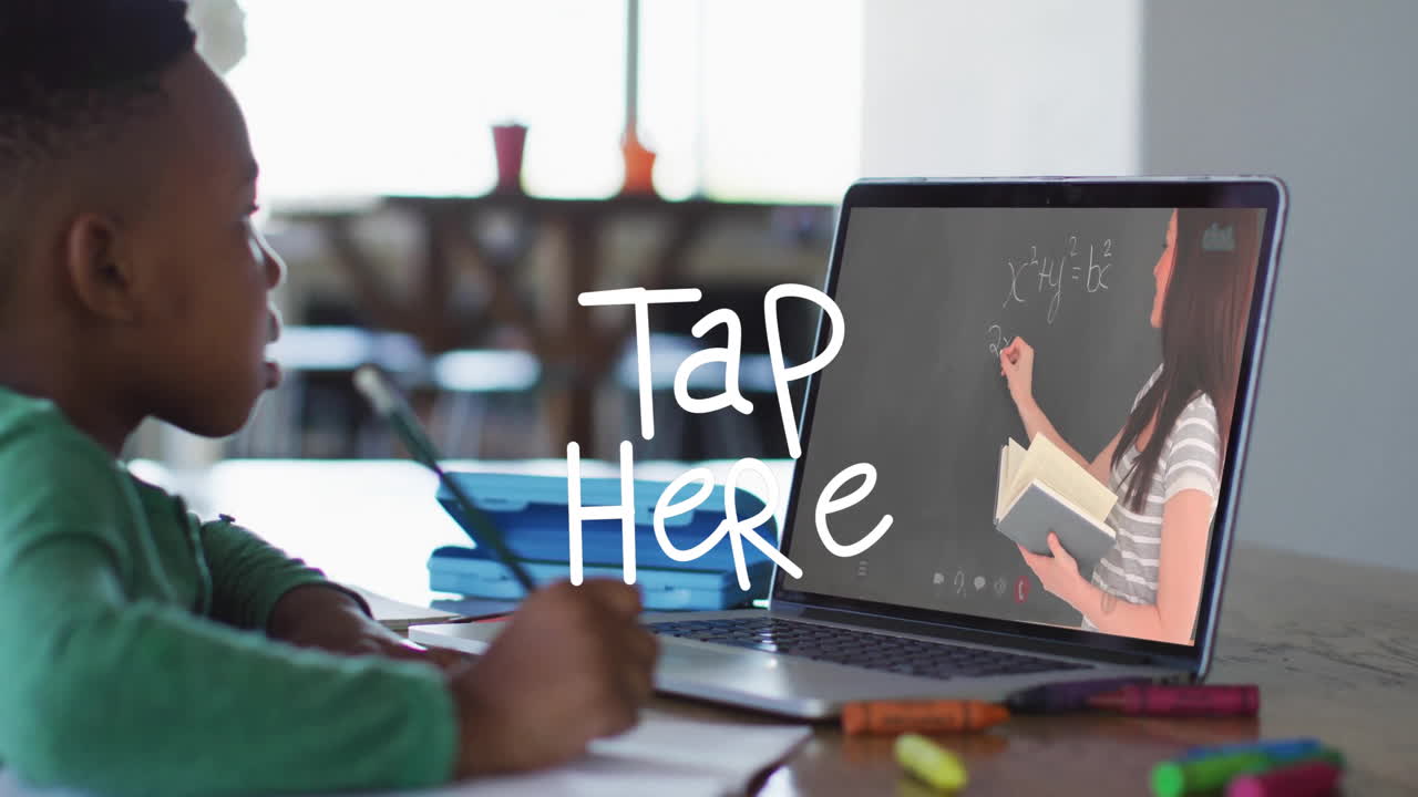 In school, child watching animation of teacher writing equations on laptop screen
