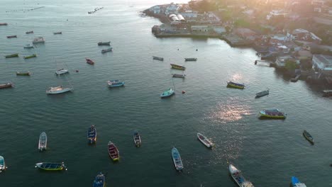 dolly in aerial view of several boats on the shore of tongoy, chile