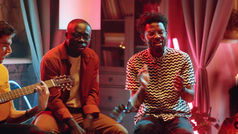 african american men singing to guitar on concert
