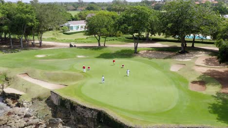 aerial view of golf course with players - golf tournament at casa de campo in la romana, dominican republic - drone shot