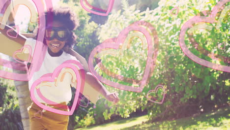 child wearing goggles running joyfully with pink heart animations over garden