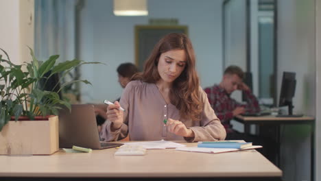 business woman working documents at coworking. closeup woman finding mistakes