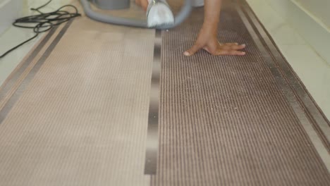 a woman vacuuming a carpet