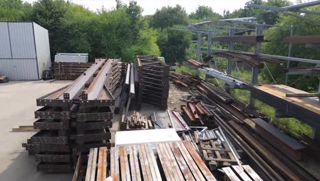 Aerial-serenity:-Drone's-eye-view-captures-the-ordered-chaos-of-metal-structural-elements-resting-on-the-ground-in-this-captivating-stock-footage