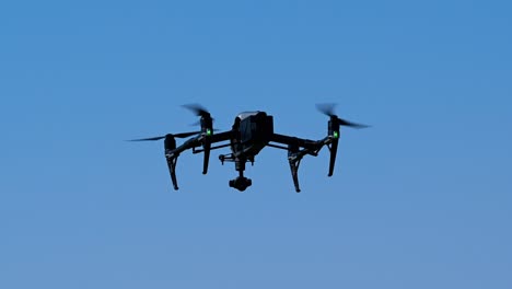 the drone hovering on a bright sunny day, drone flying, drone camera, quadcopters