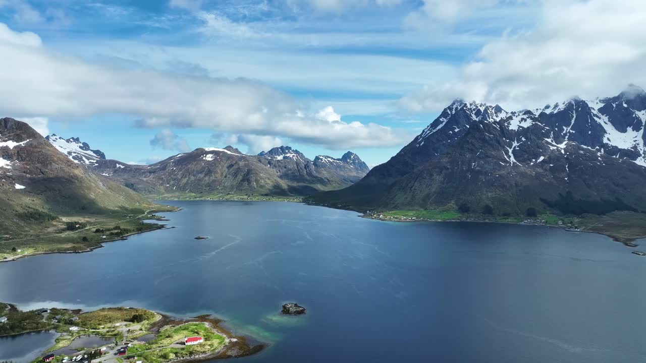 Small settlement at Sildpollneset in Austnesfjorden with Lofotveggen peaks in the distance