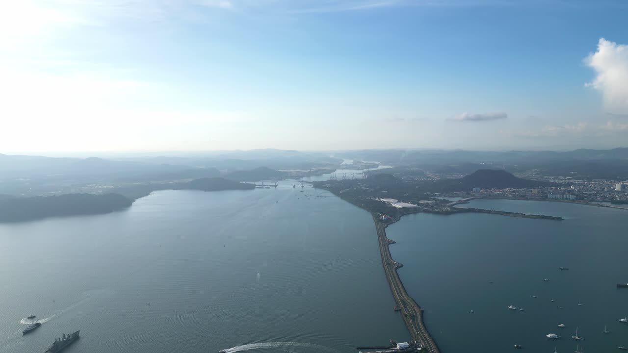 A long wide drone shot of the Panama Canal in Central America, Panama, during daytime.