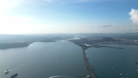 a long wide drone shot of the panama canal in central america, panama, during daytime.
