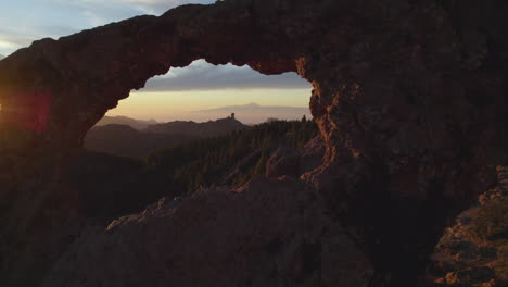 cinematic shot through the window of roque nublo during sunset