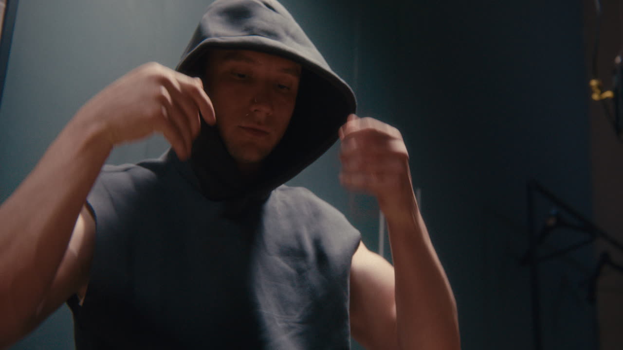 Man putting on a hoodie