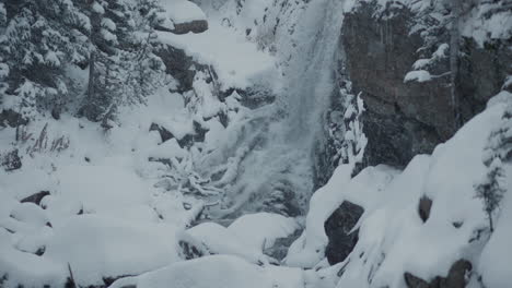 winter waterfall in snowy mountains