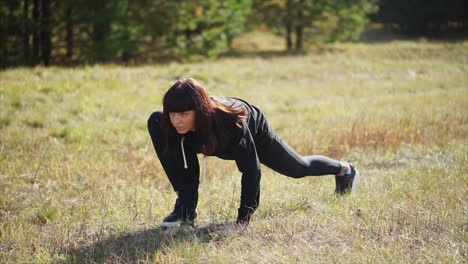 woman stretching outdoors in a forest
