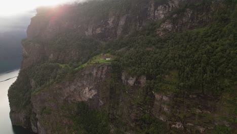 Skageflå-Mountain-Farm-On-Steep-Mountainside-Along-Geiranger-Fjord-in-Norway,-Aerial-View