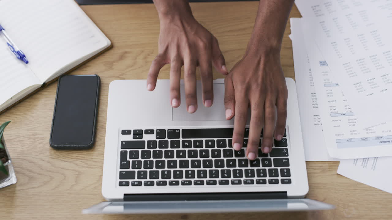 Person working on a laptop at a desk