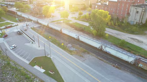 aerial view of train tracks and cityscape at sunset
